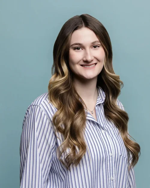 Corporate team headshot for Fluor: woman in a striped shirt on a teal backdrop, Greenville, SC