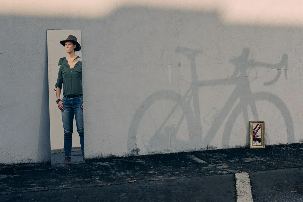 Cyclocross athlete Hannah Arensman with her bike, mirror portrait, Morganton NC editorial photography by Jack Robert