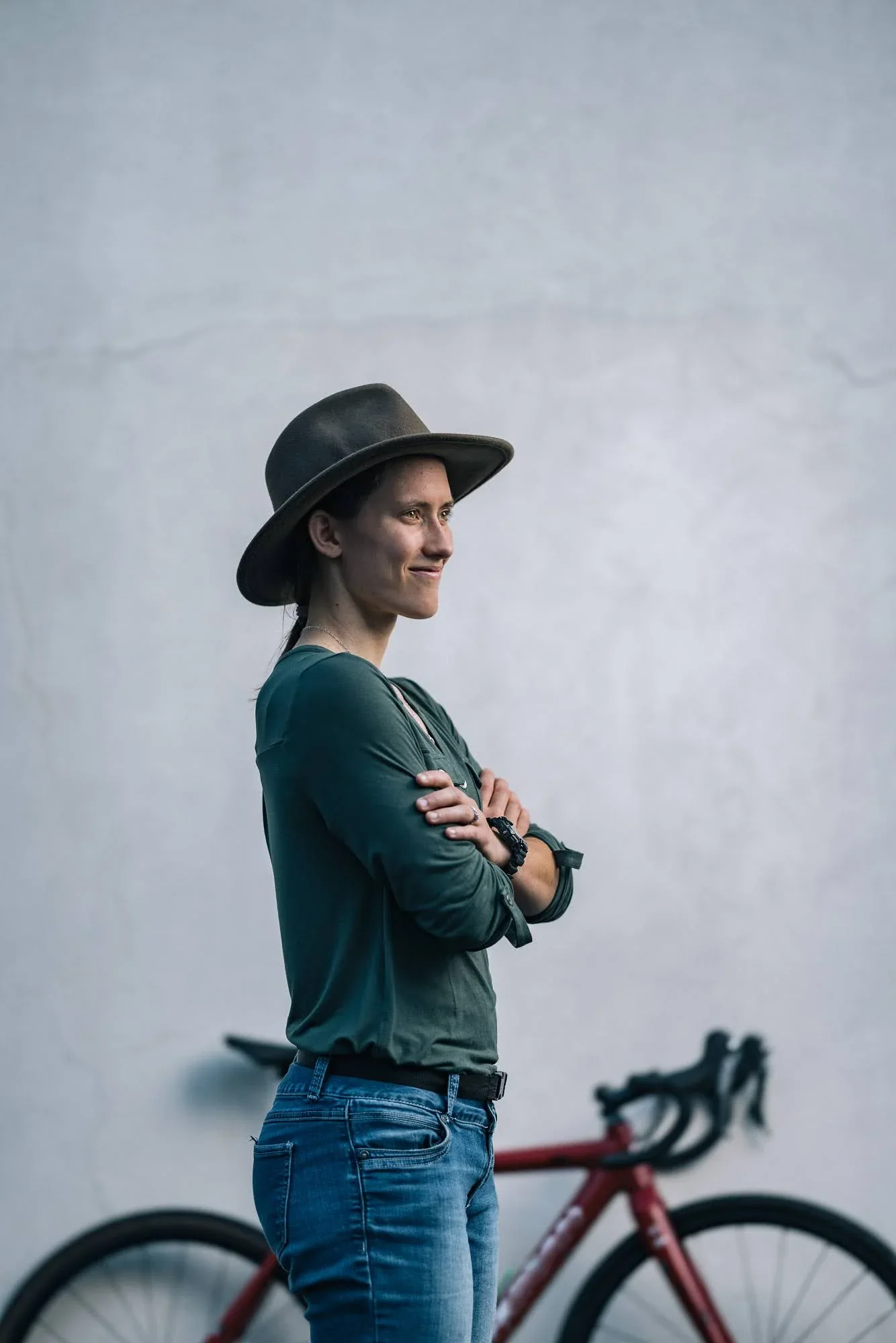 Profile portrait of Hannah Arensman in a hat with her bike, editorial cyclocross photography Morganton NC by Jack Robert
