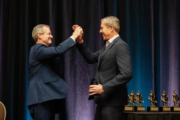 Award handshake and celebration on stage at a corporate awards night in Greenville SC by Jack Robert Photo