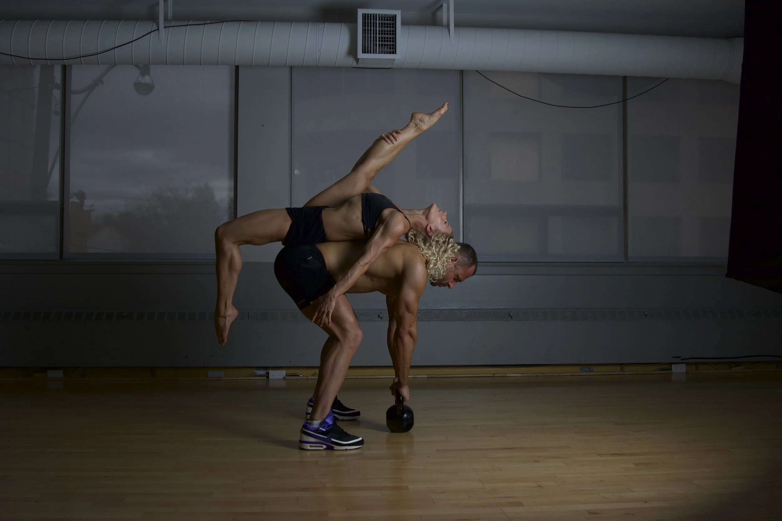Paula and Vlad in a kettlebell partner lift at Ultimate Athletics