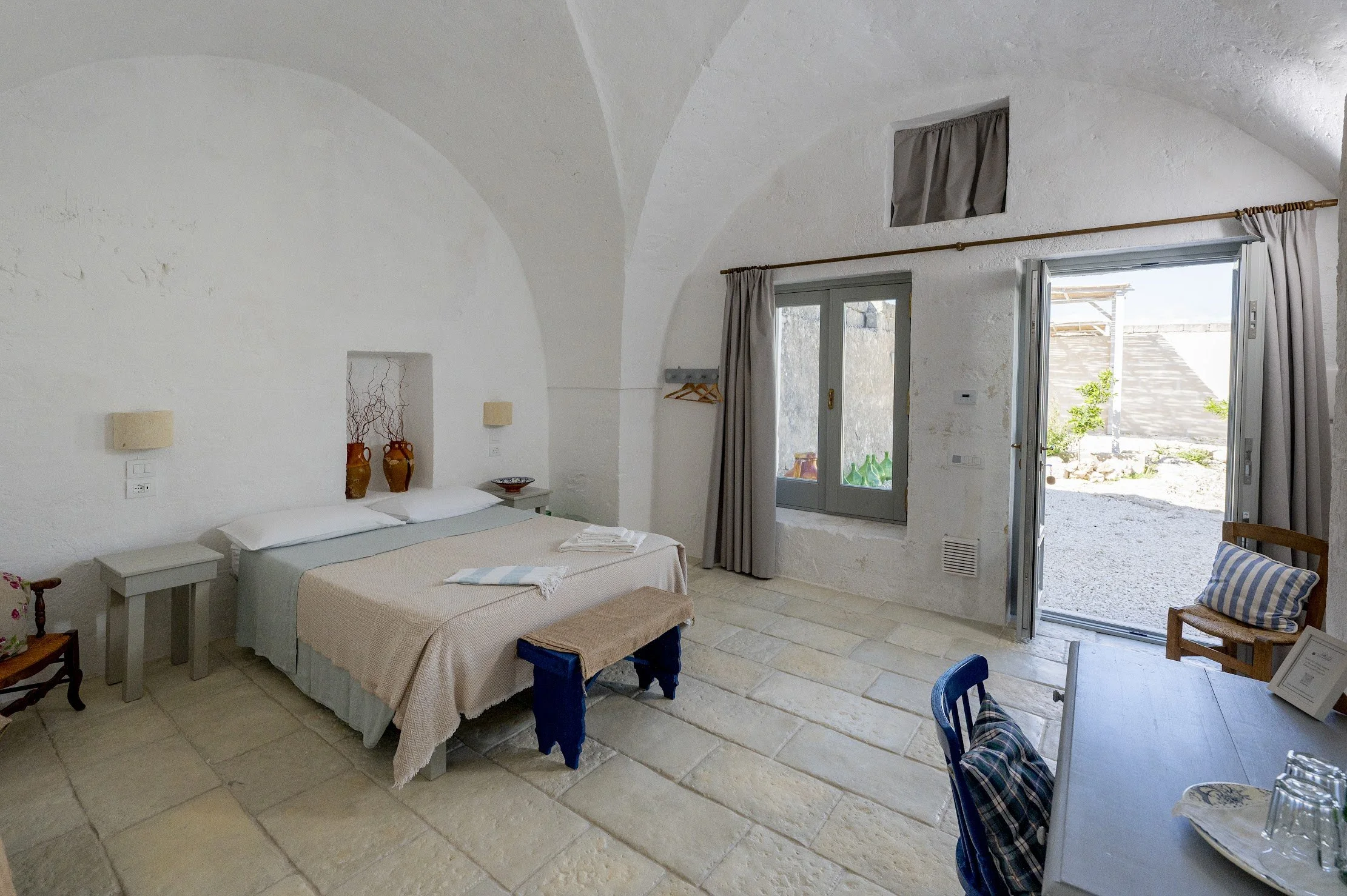 Private room with stone arch and bamboo headboard