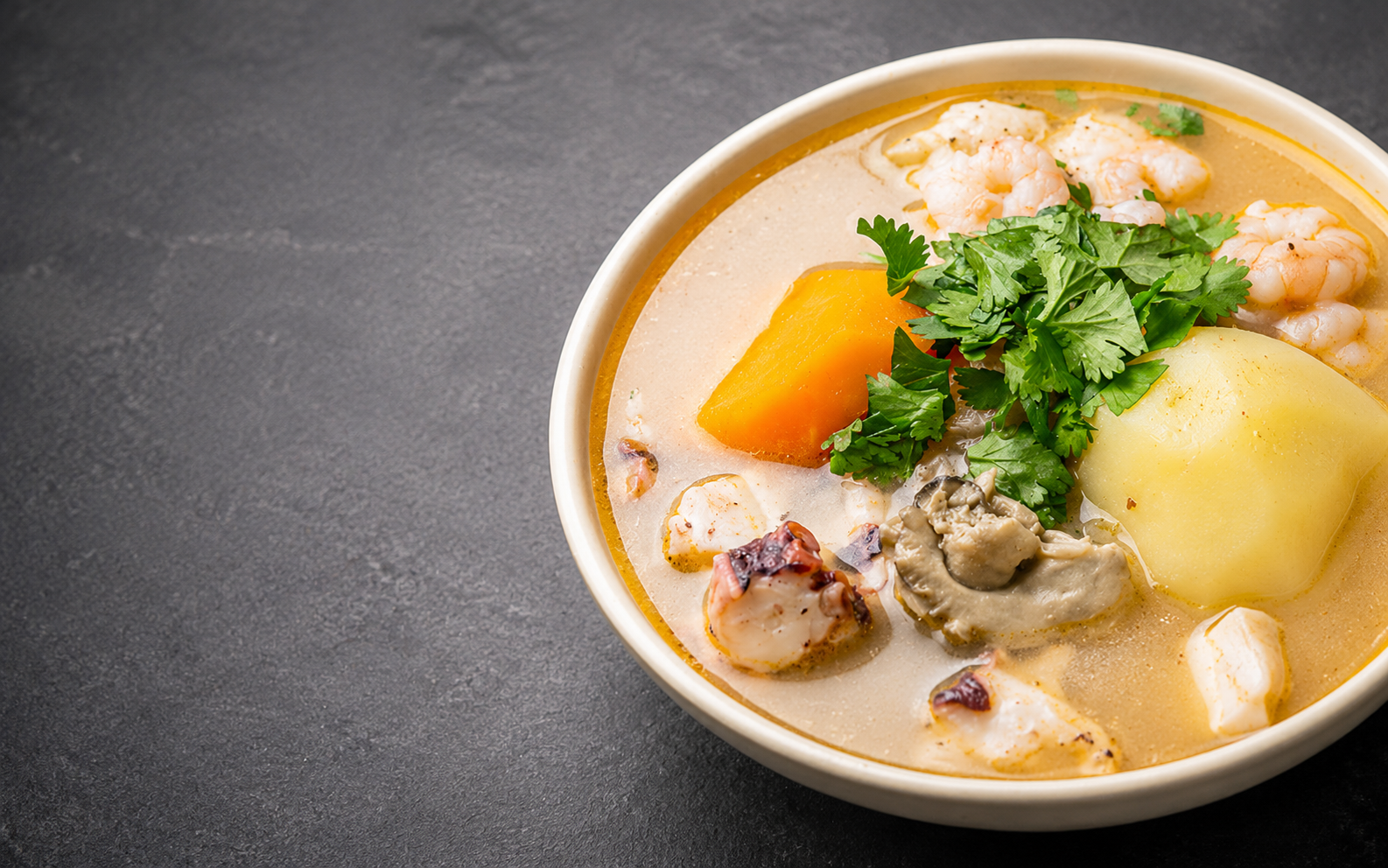 Connie's seafood soup with shrimp, seafood, vegetables, and fresh herbs