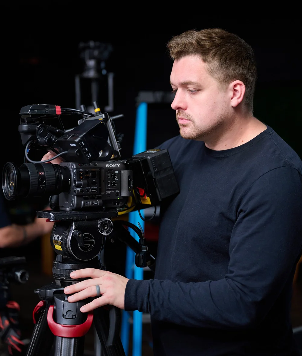 Drew Vernon behind a Sony FX6 on set
