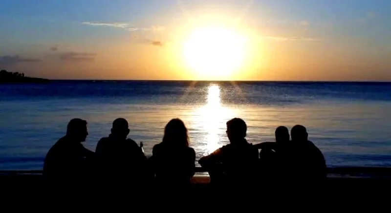End-of-day deck scene — Coconut Tree Divers crew and divers winding down at sunset