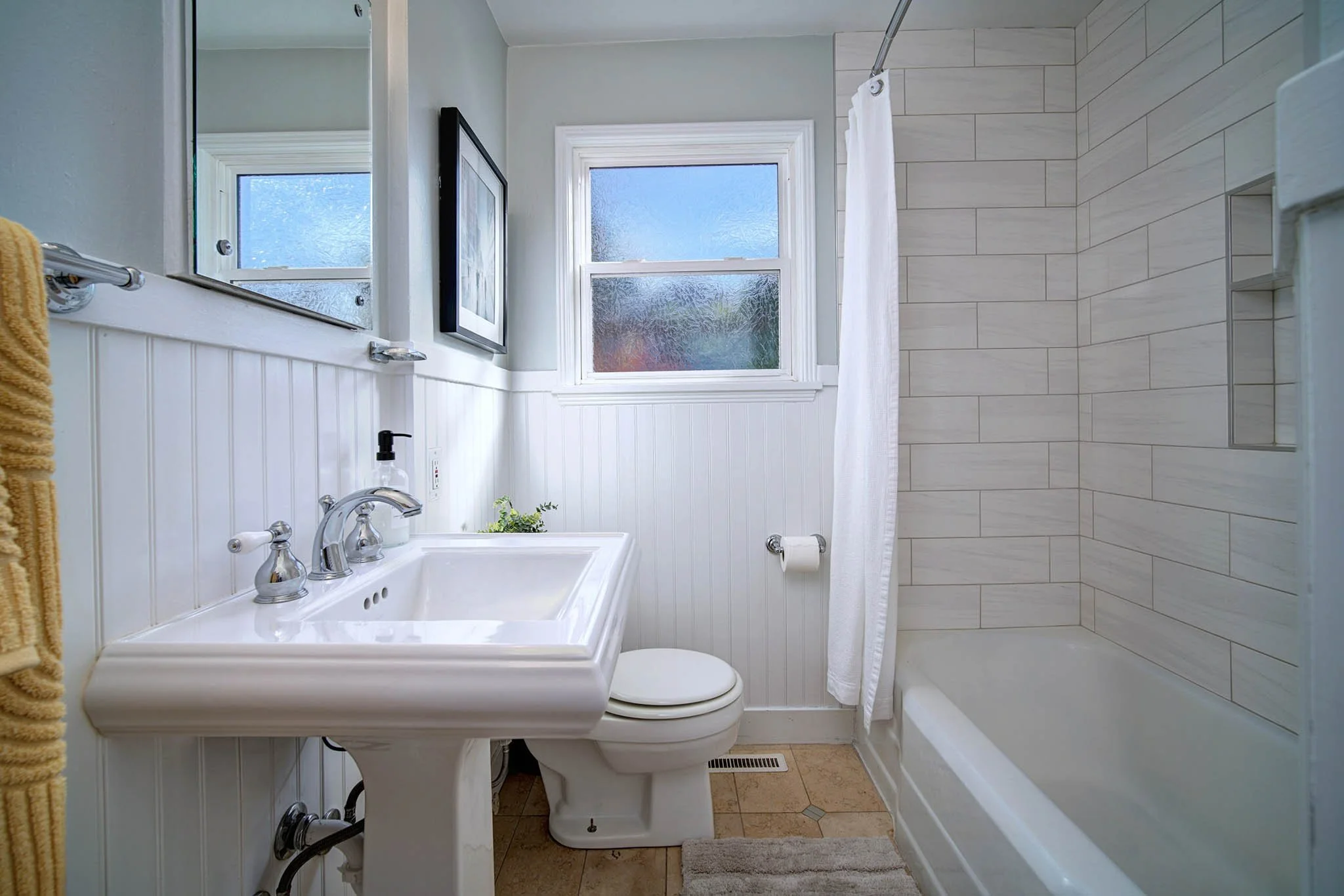 Updated bathroom with tiled tub surround