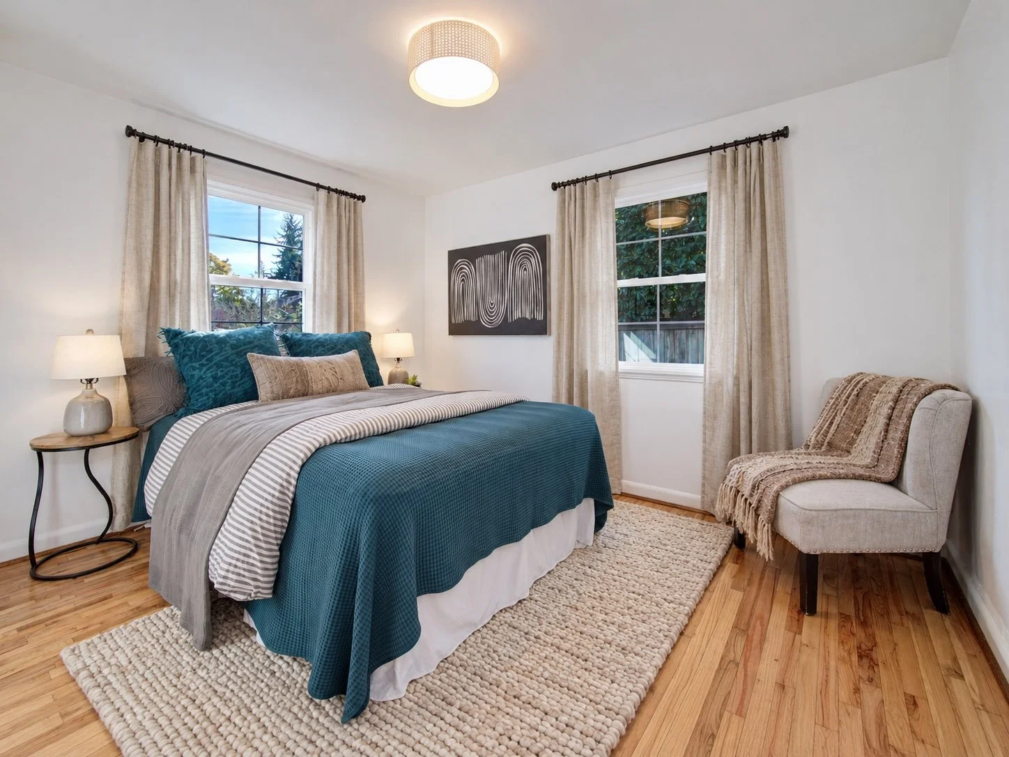 Second bedroom with hardwood floors and natural light