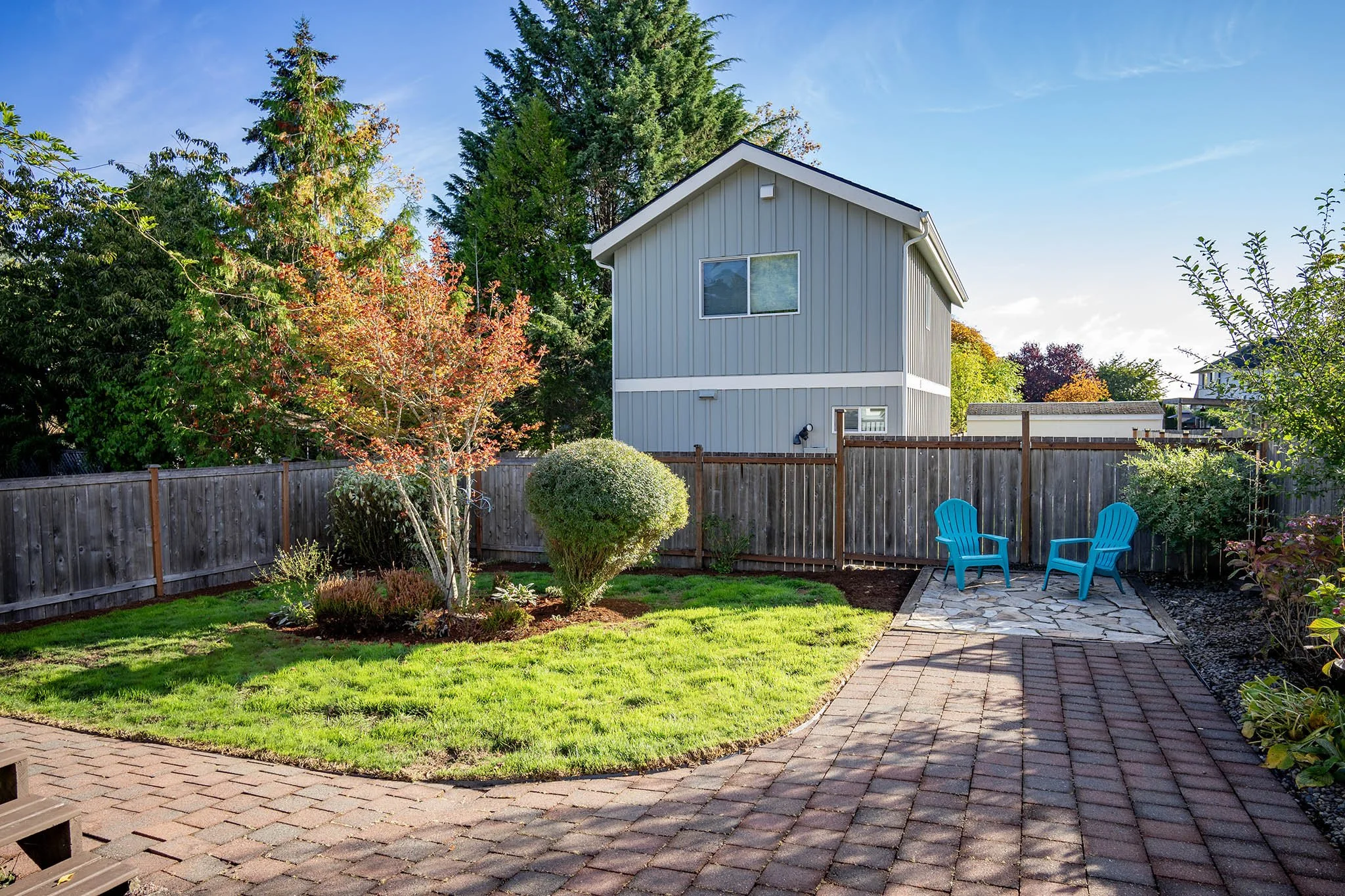 Large fully fenced backyard with flagstone patio