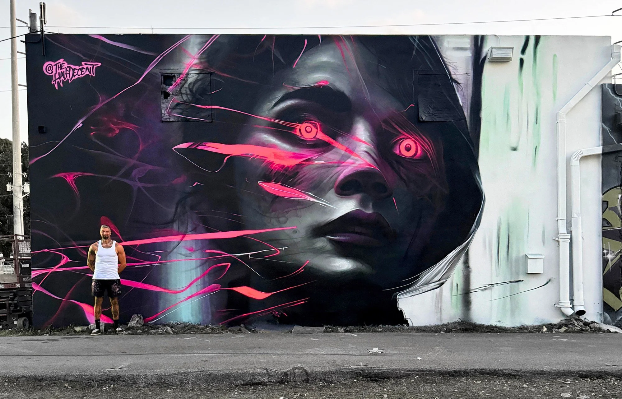 Laserface, a monumental portrait with vivid pink light trails in Wynwood, Miami