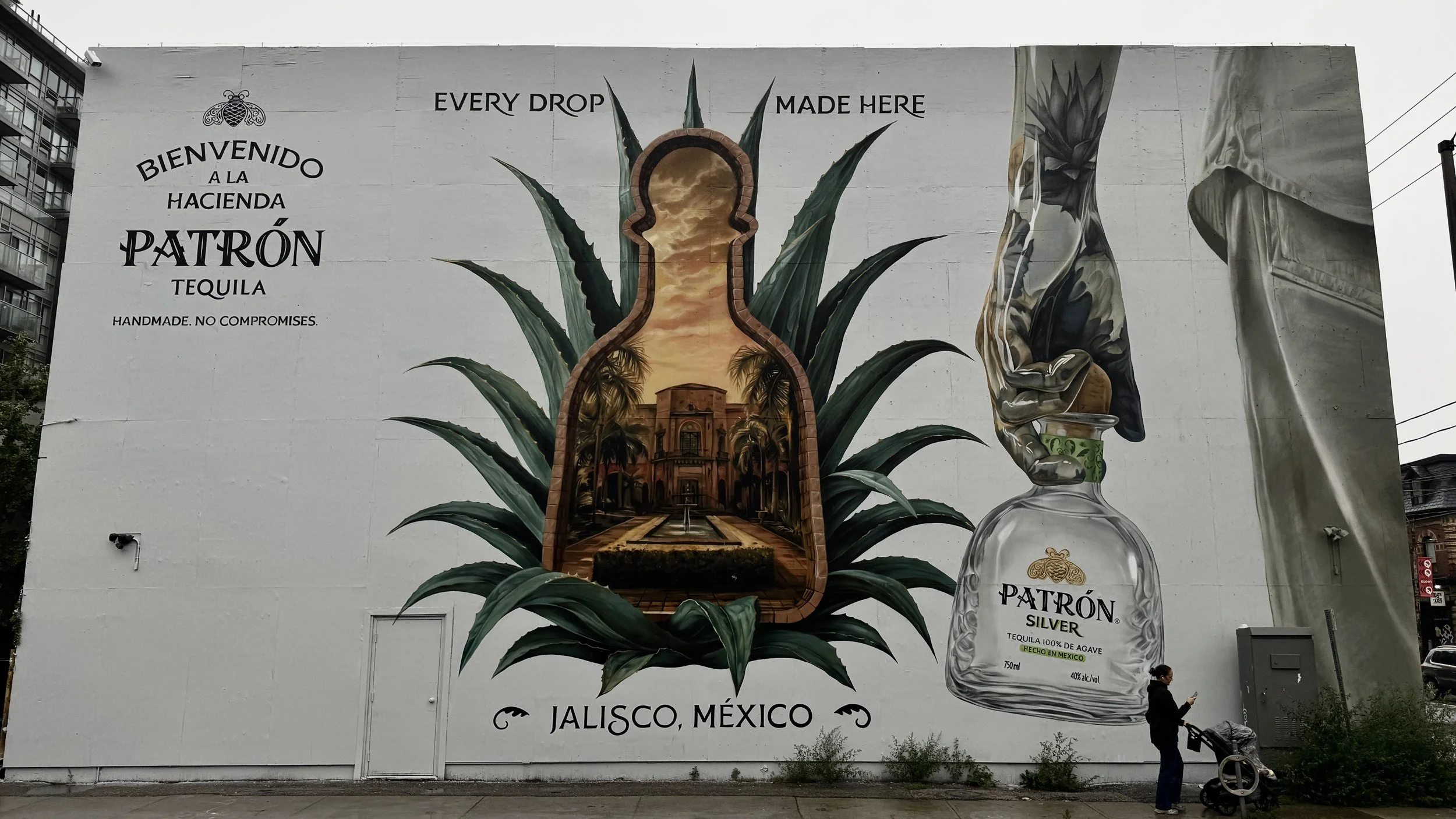 Patrón exterior mural with an agave plant, hacienda scene and hand pouring tequila