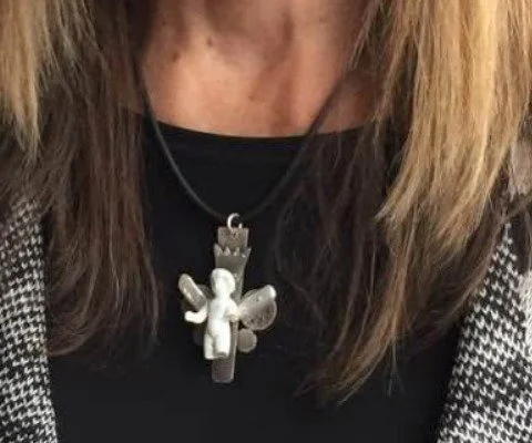 Handmade silver pendant necklace by Jackie Jordan Studio worn on a black top