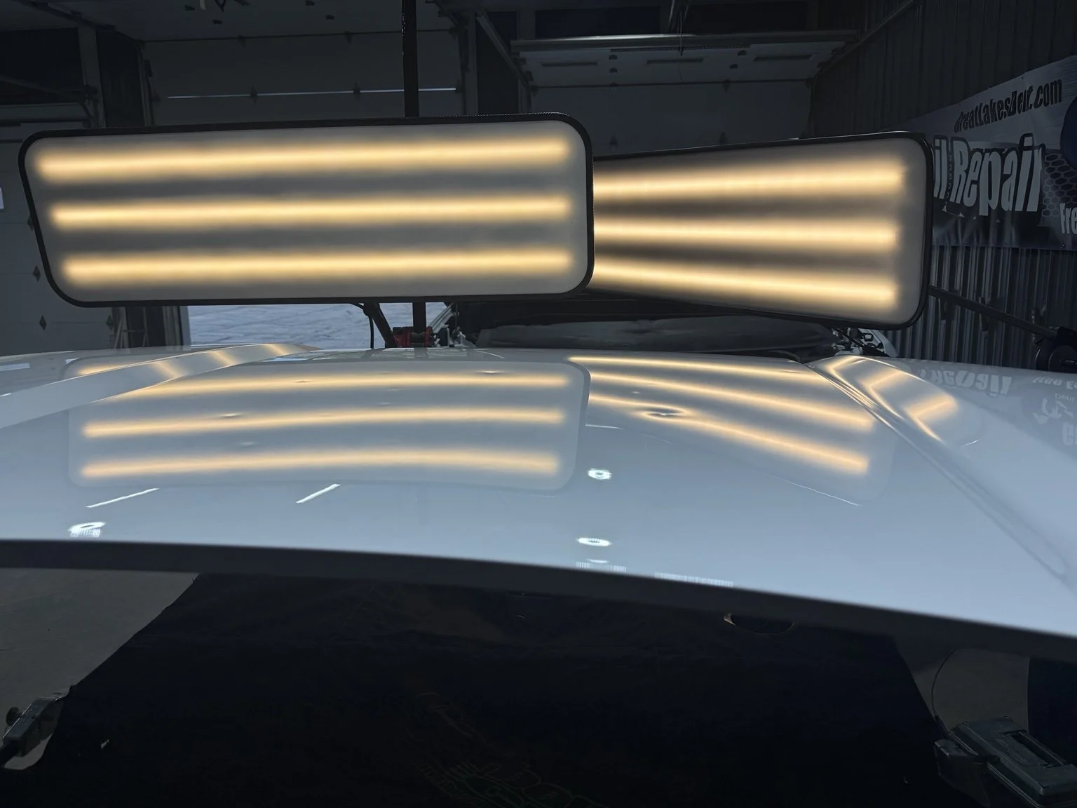 Hail dents visible on a vehicle hood before Paintless Dent Repair