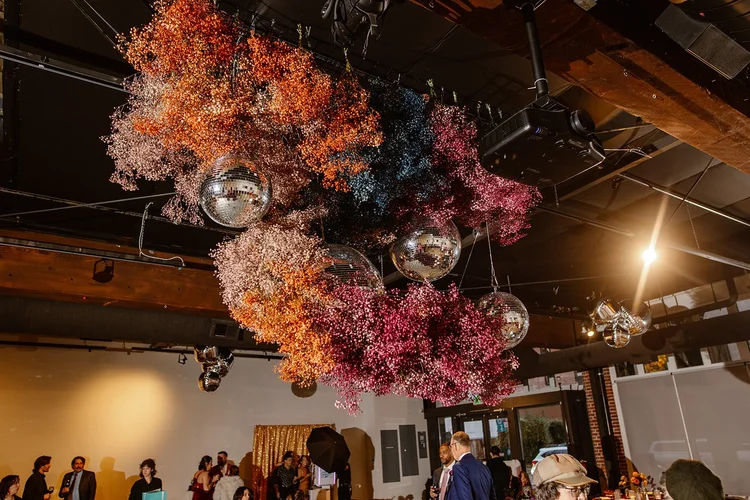 A hanging floral installation at a wedding.