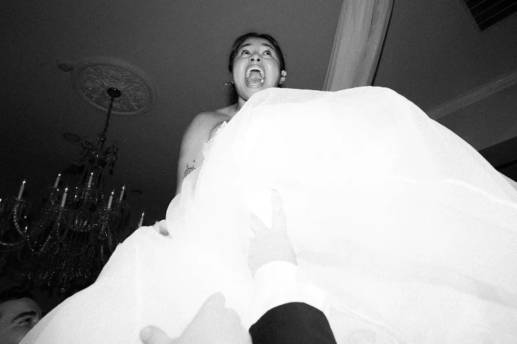A bride screams in delight on her wedding day.