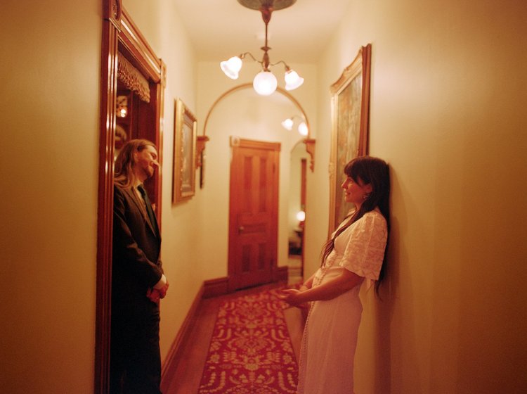 A bride and groom look at each other lovingly on their wedding day.