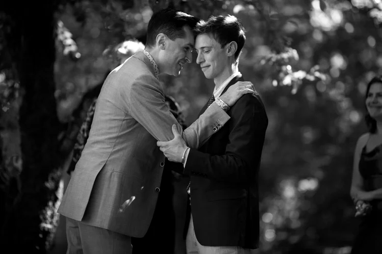 Two grooms hug on their wedding day.