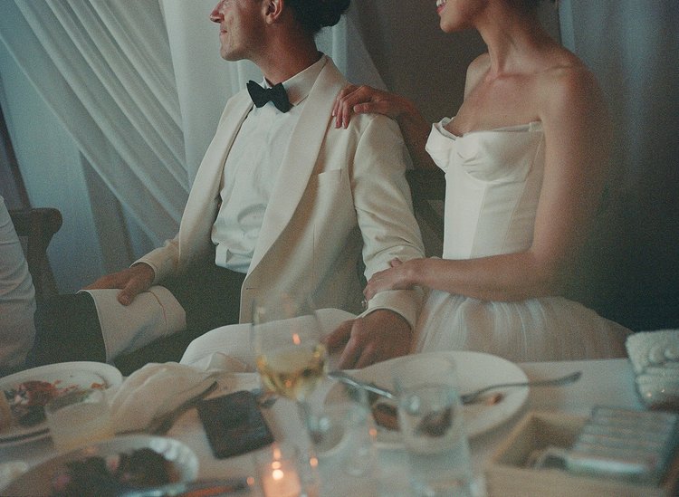 A bride and a groom hold hands on their wedding day.