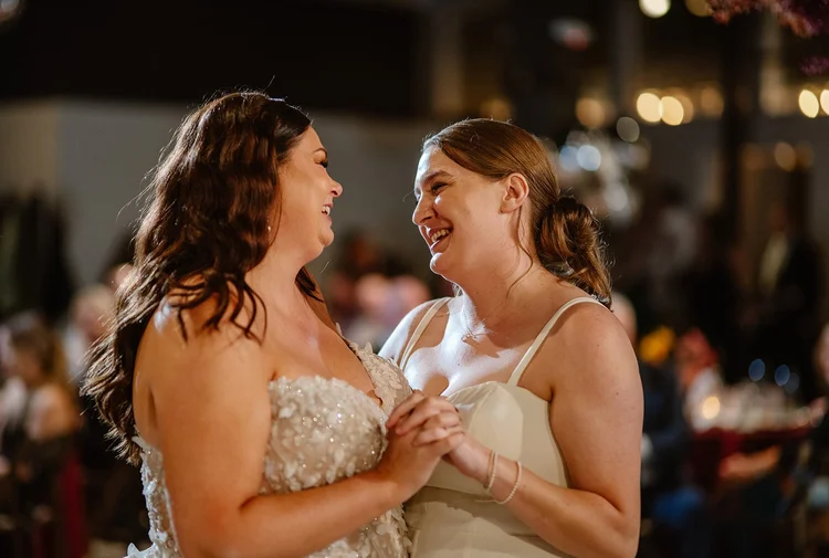 Two brides dance at their wedding.