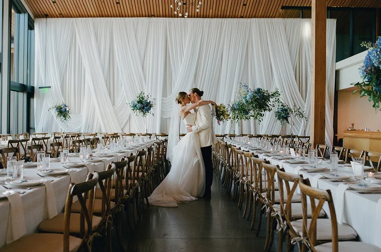 A bride and groom kiss on their wedding day.