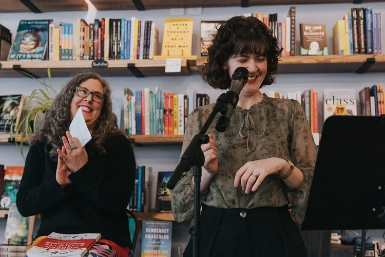Elisabeth Kramer and Emily Sterling laugh during Elisabeth's book reading in February 2025.