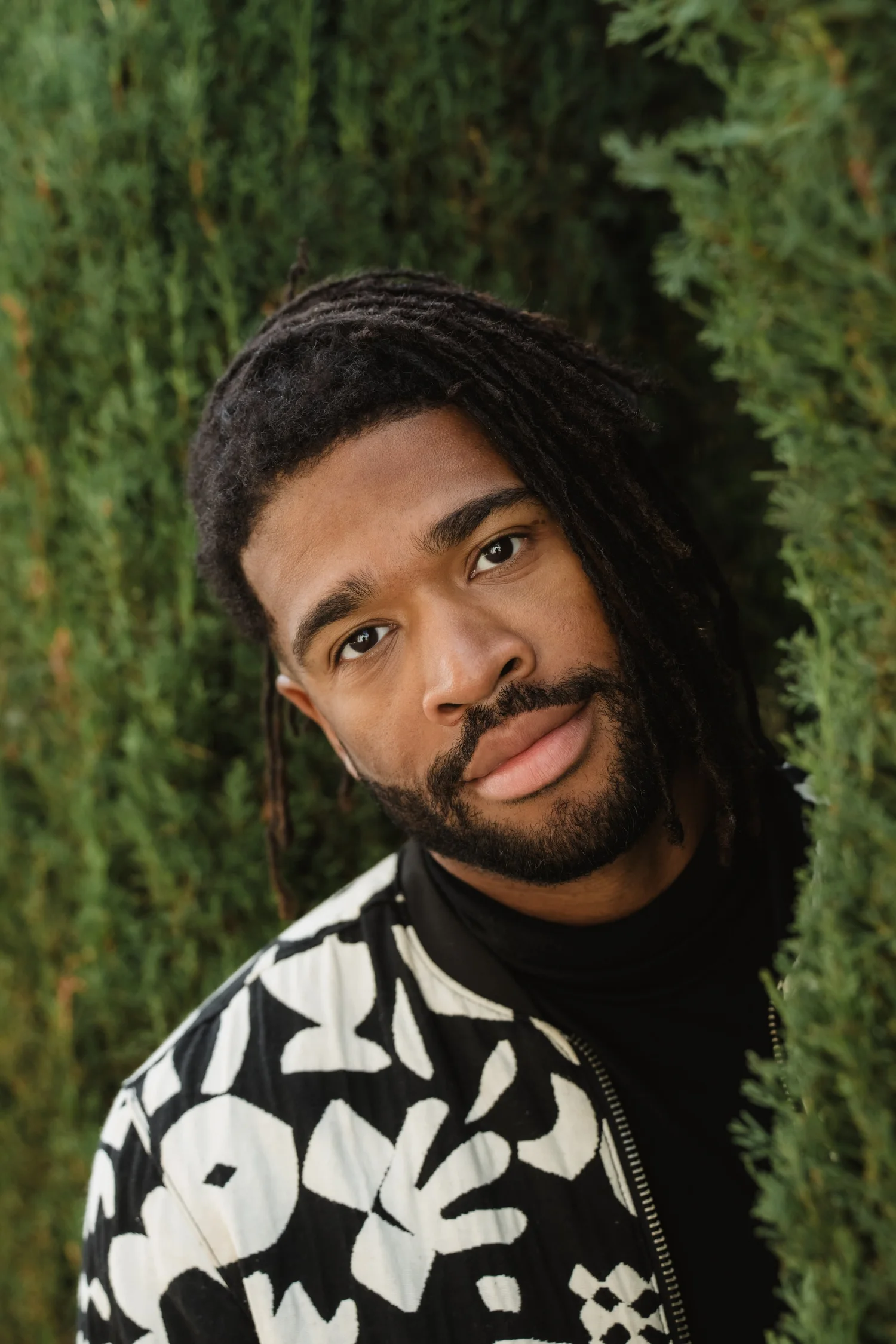 Darius Christian framed by greenery, photographed by Valerie Jendryke