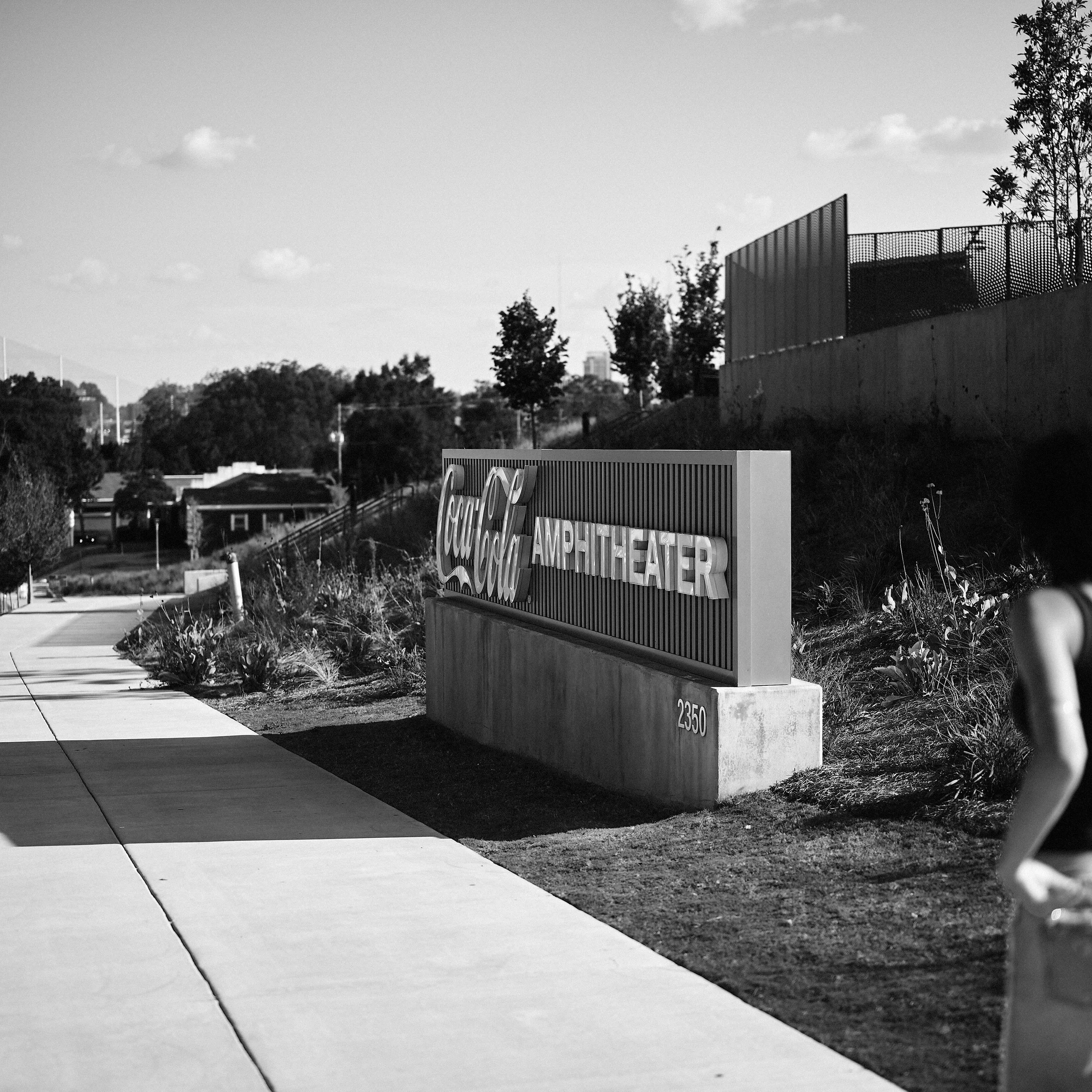 Sidewalk and landscaped edge alongside Coca-Cola Amphitheater in Birmingham