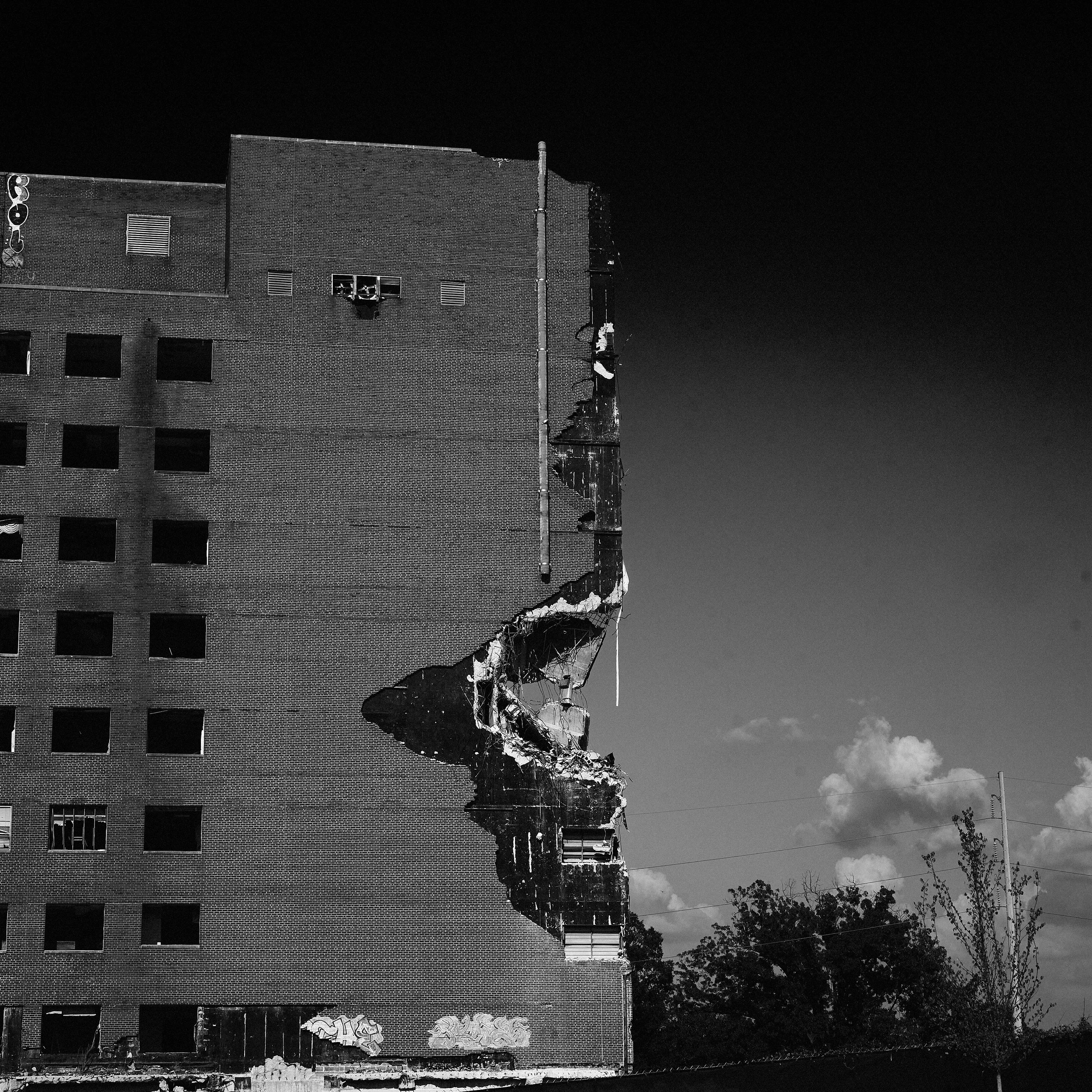 Closer view of the remaining brick facade and exposed edge of a partially demolished building