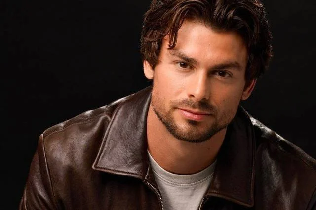 Actor headshot with a dark studio background