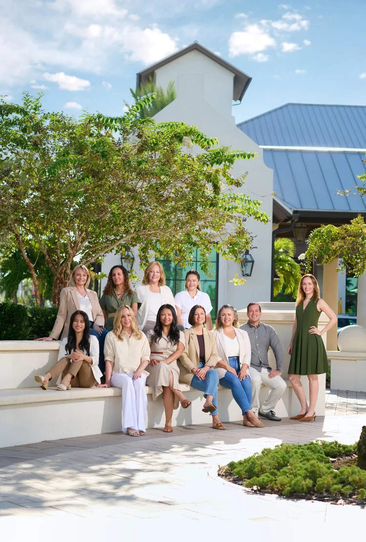 Team portrait outside an office building.