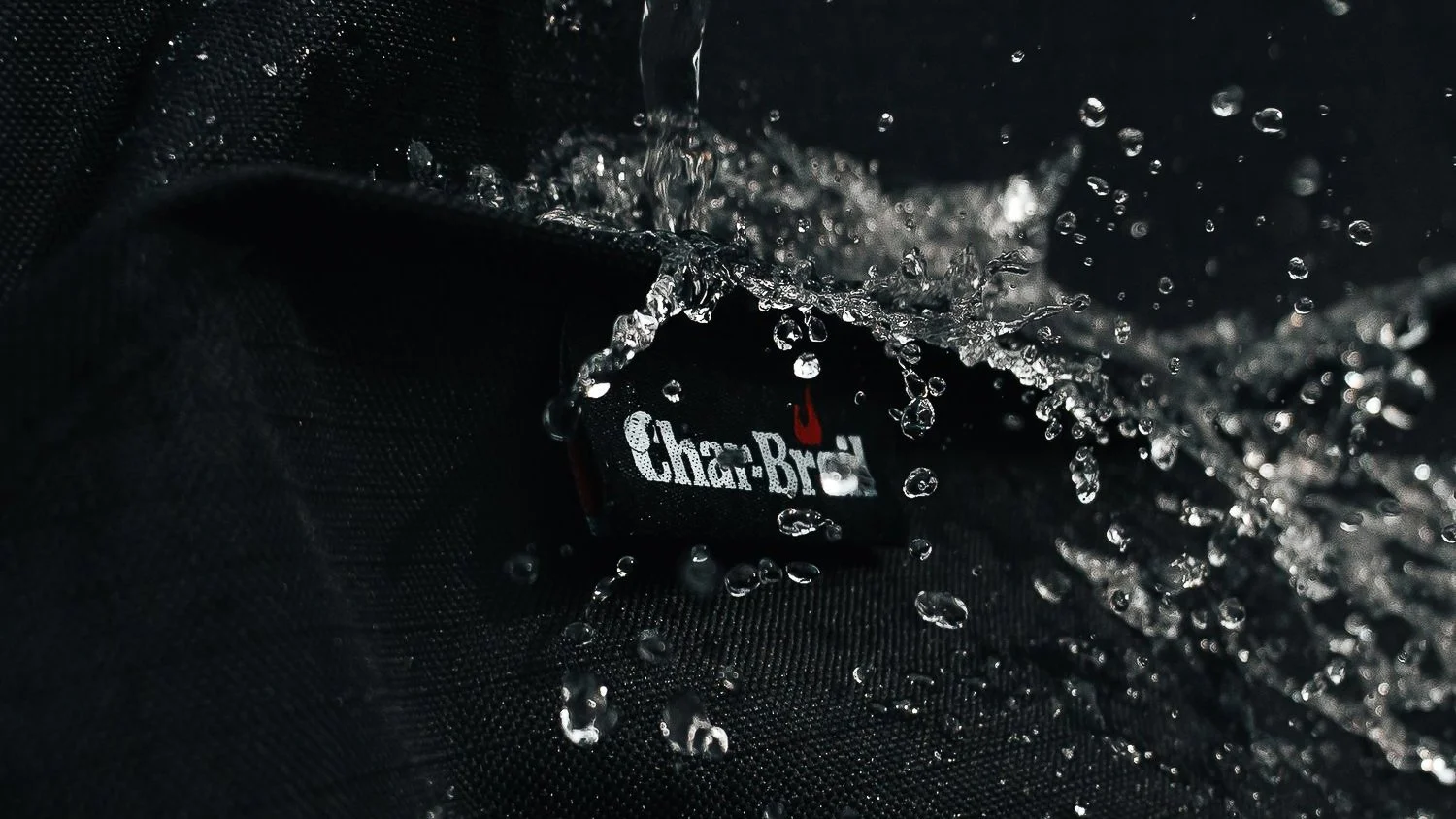 Pittsburgh commercial product photography by Ian Jones of ISJDesigns showing a Char-Broil logo with water splashing across black fabric.