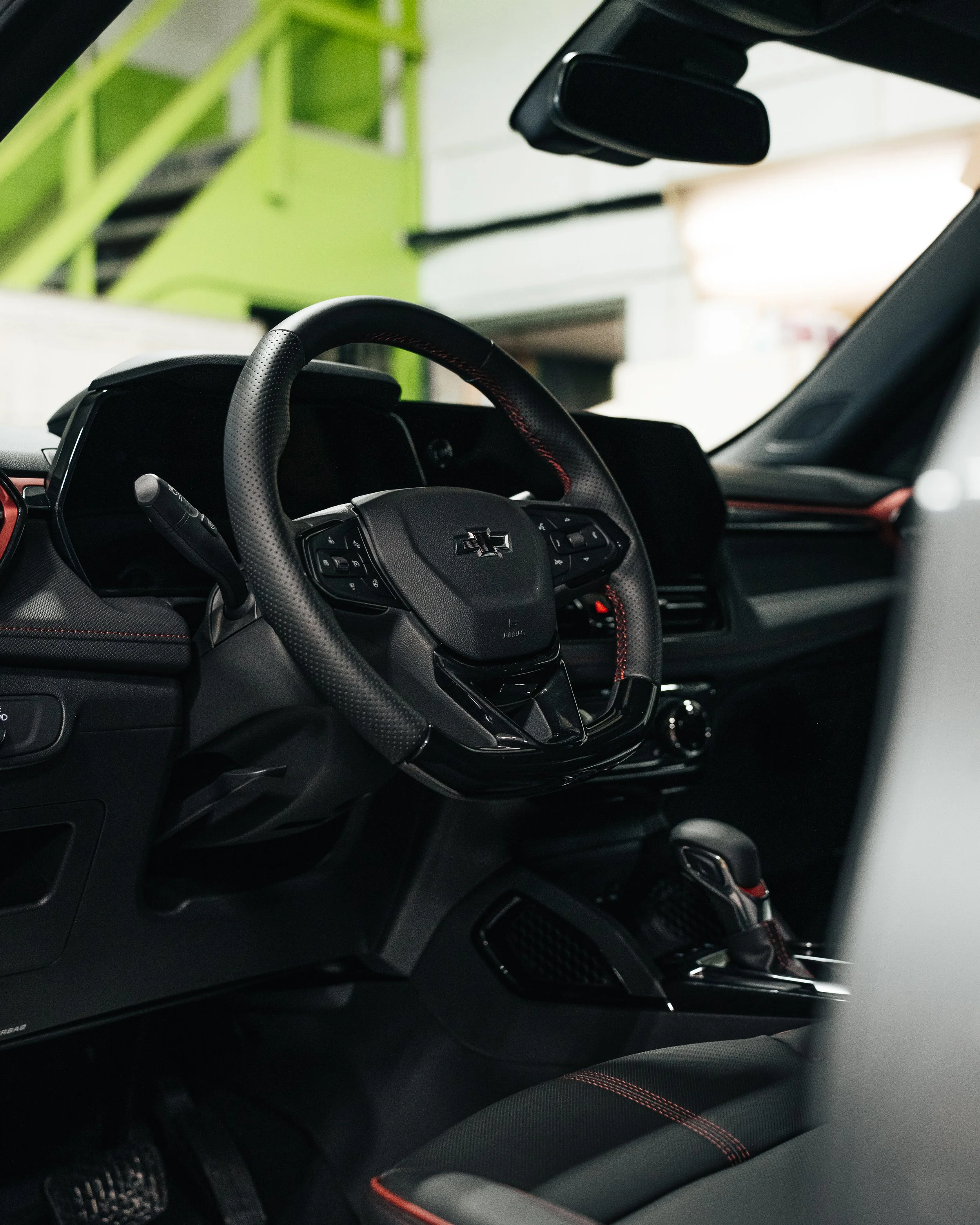 Detailed automotive interior photography of a Chevrolet steering wheel and black cabin by Pittsburgh photographer Ian Jones