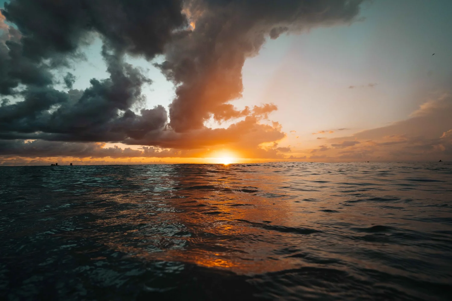 Gulf of Mexico sunset beneath dramatic storm clouds on Anna Maria Island, Florida, destination image for hotel, resort, and hospitality marketing.