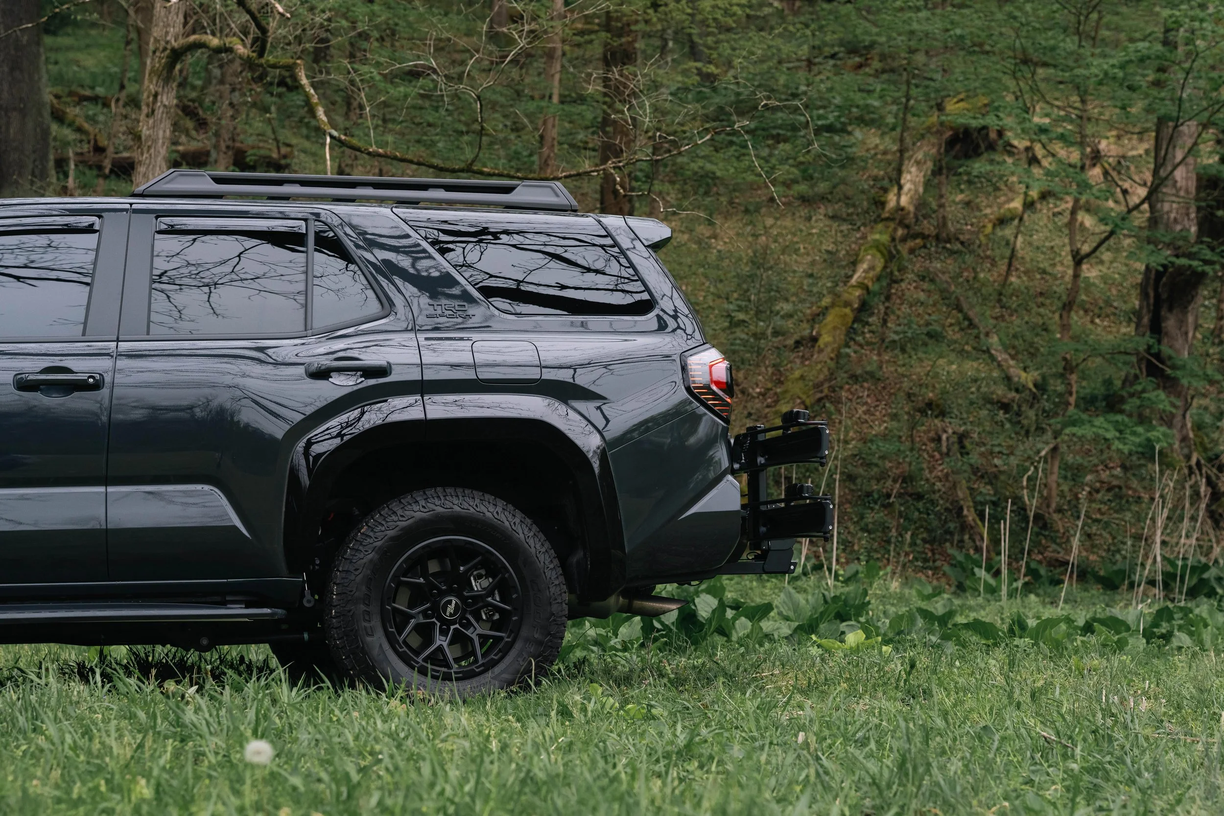 Side angle of the Kuat Piston Pro X bike rack on Ian Jones' 2025 Toyota 4Runner TRD Sport, showing a no-frame-contact hitch rack setup, adventure gear fitment, and real-world 2025 4Runner bike rack documentation.