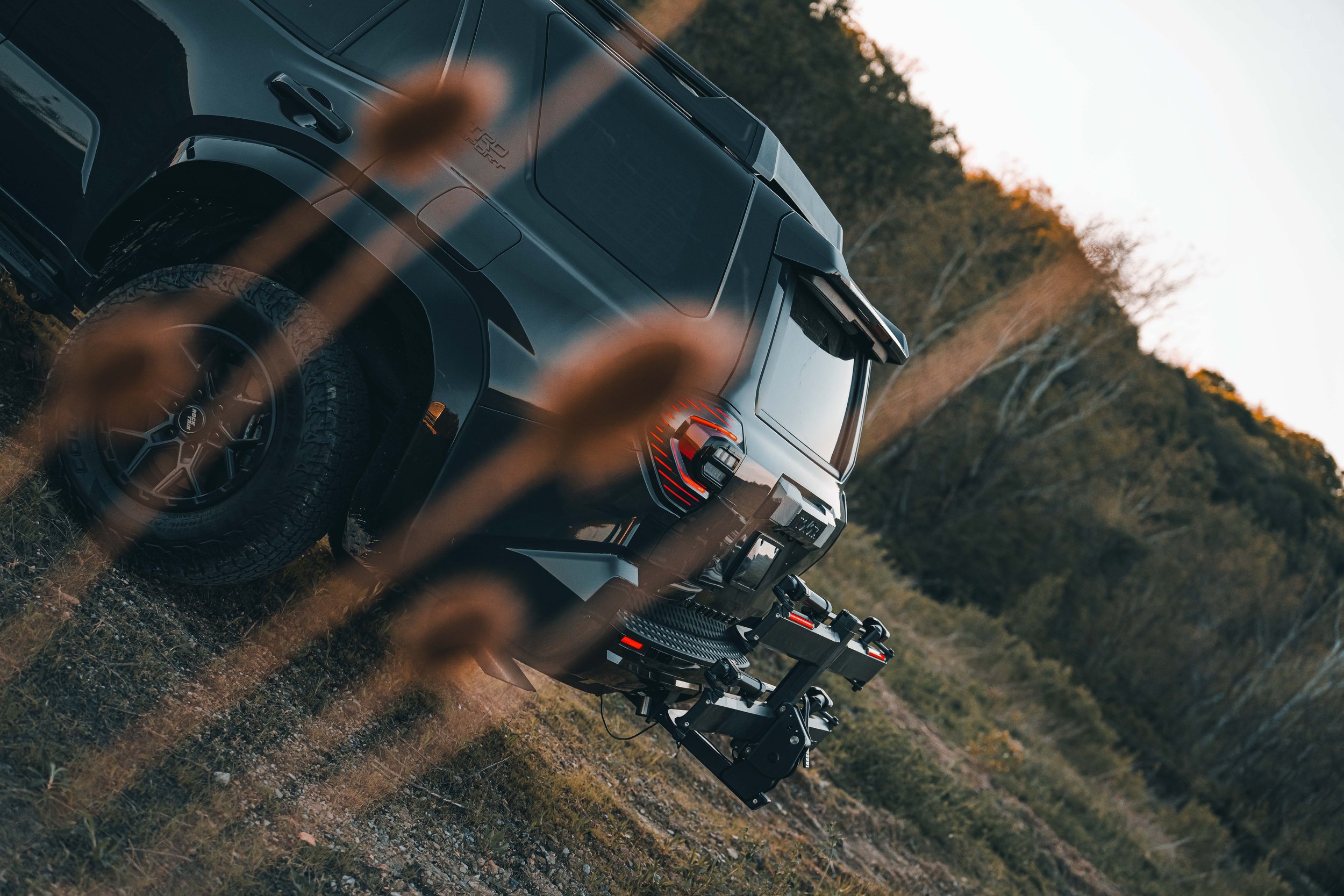Wide environmental shot of Ian Jones' 2025 Toyota 4Runner TRD Sport in Underground gray with the Kuat Piston Pro X hitch bike rack installed, captured for the ISJDesigns long-term review of the Piston Pro X against competing racks from Thule, Yakima, and 1UP USA.