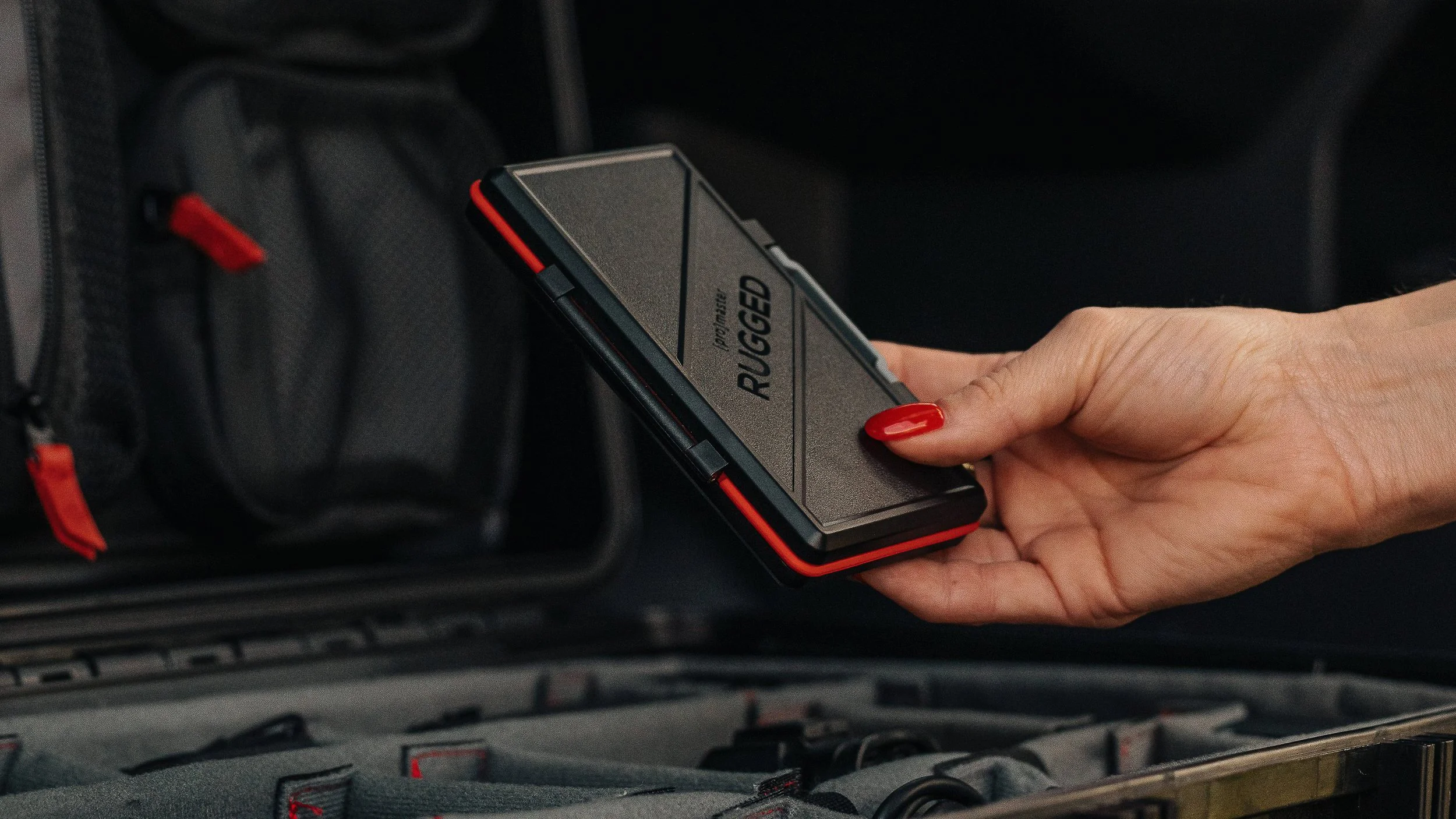 Commercial product photography by Ian Jones of ISJDesigns showing a ProMaster Rugged memory card case held above a camera gear case.