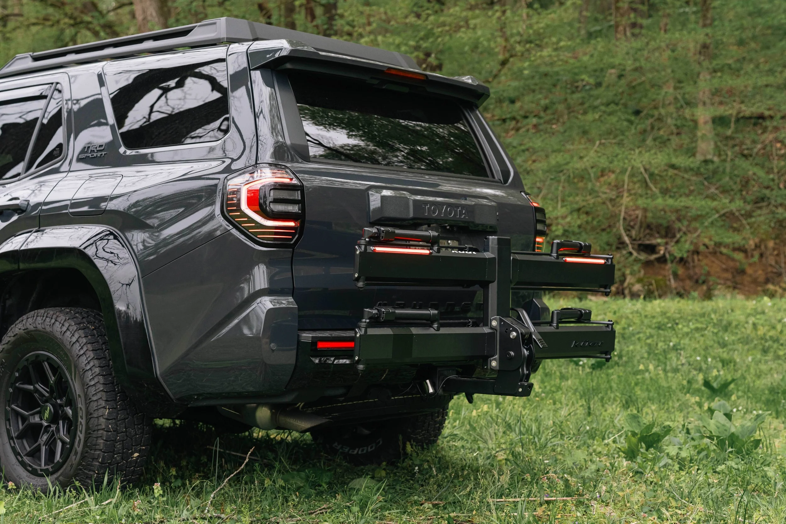Detail view of the Kuat Piston Pro X matte black powder coat finish and Kashima-coated struts on the rear of Ian Jones' 2025 Toyota 4Runner TRD Sport, showing the premium design language that separates it from competing hitch racks.