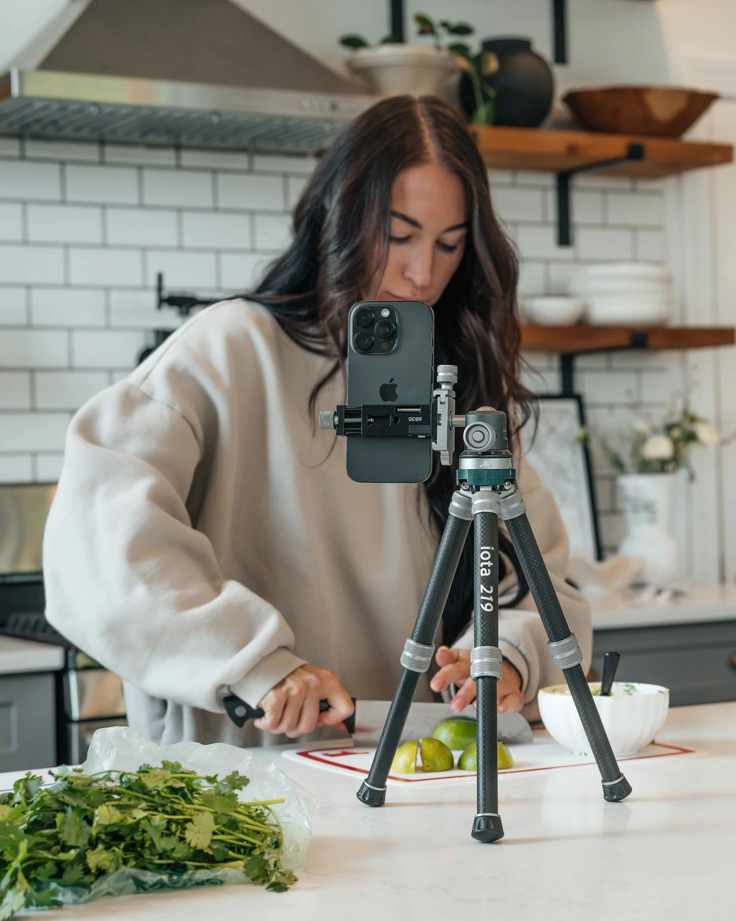 Creator slicing limes behind a ProMaster iota 219 tripod recording the prep on an iPhone