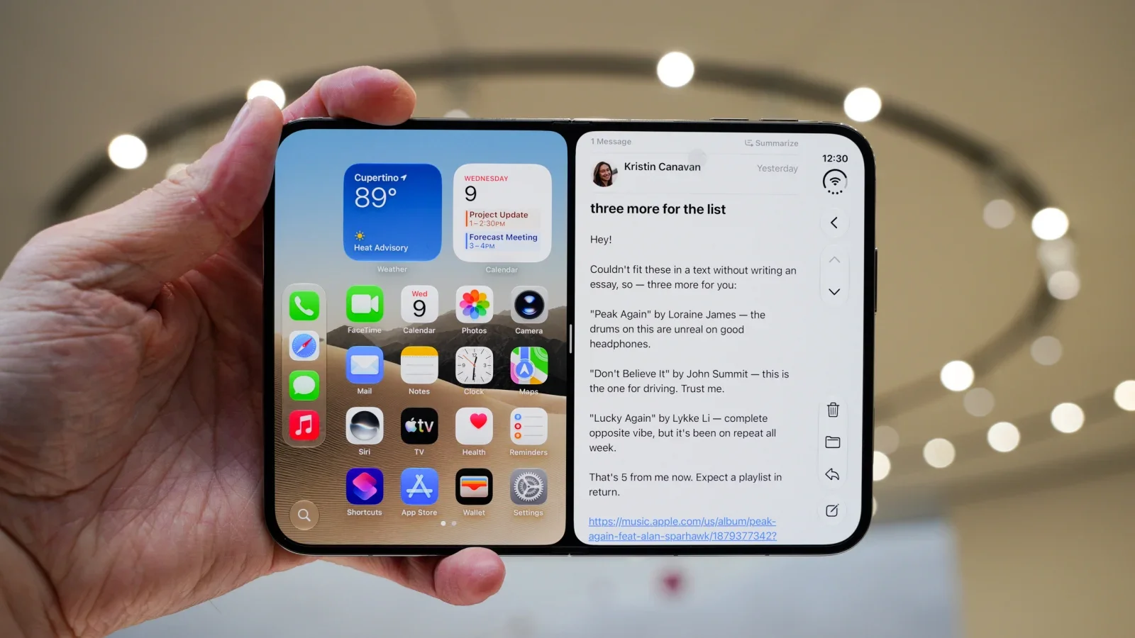 Apple iPhone Duo opened to its 7.6-inch foldable display, held in one hand while Split View shows the Home Screen and widgets beside an open Mail message for iPhone multitasking.