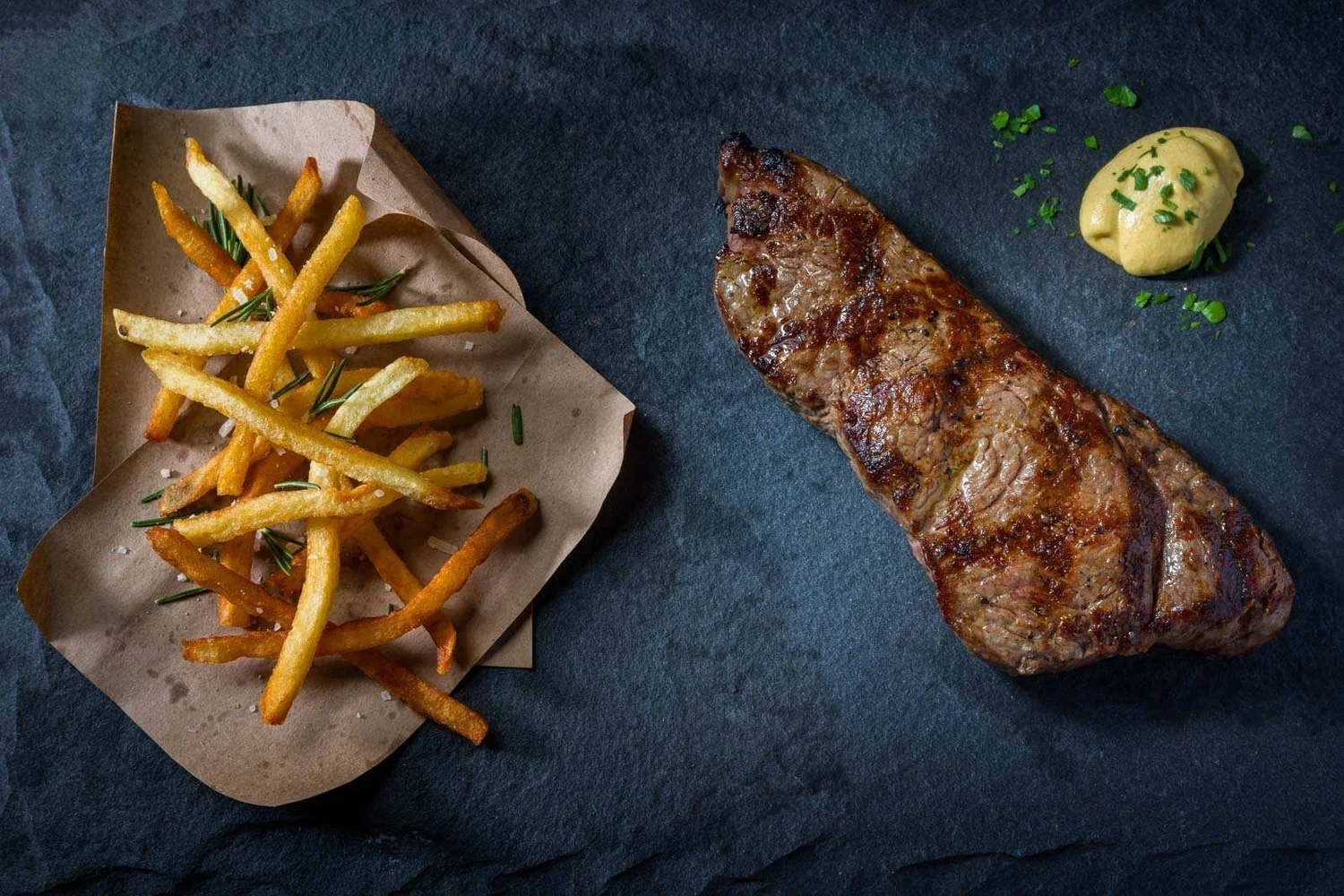 Steak frites with golden fries and mustard sauce