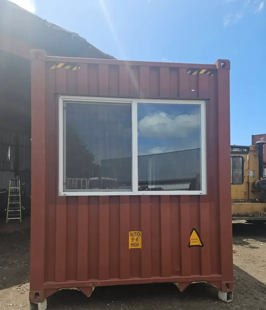 Exterior of Kathy Bird's modified shipping container with a large sliding window