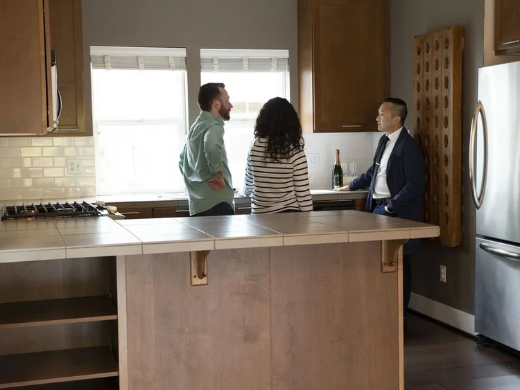 Brian Huie touring a Seattle kitchen with two buyers