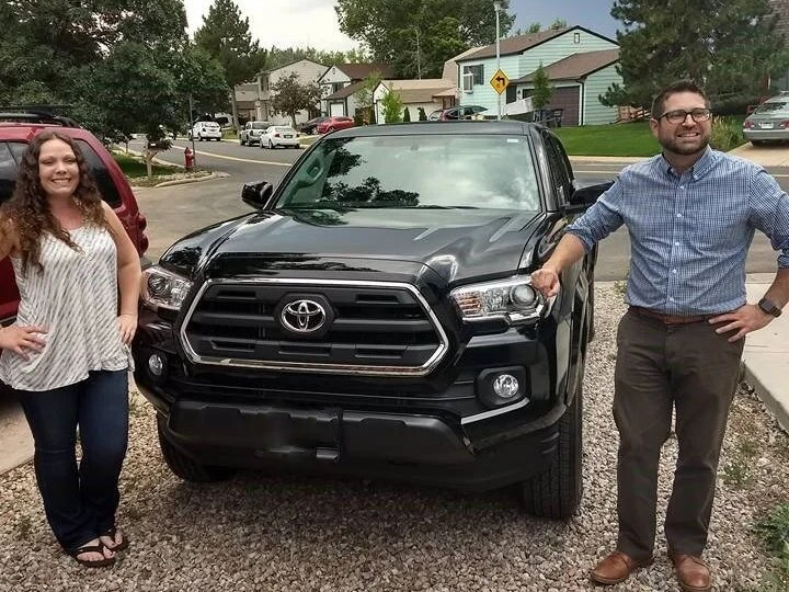 Auto Broker Colorado delivery — handing over the keys to a client's new Toyota Tacoma in their Colorado driveway, no dealership visit required.