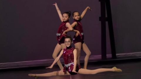 Jazz dancers in maroon sequin costumes