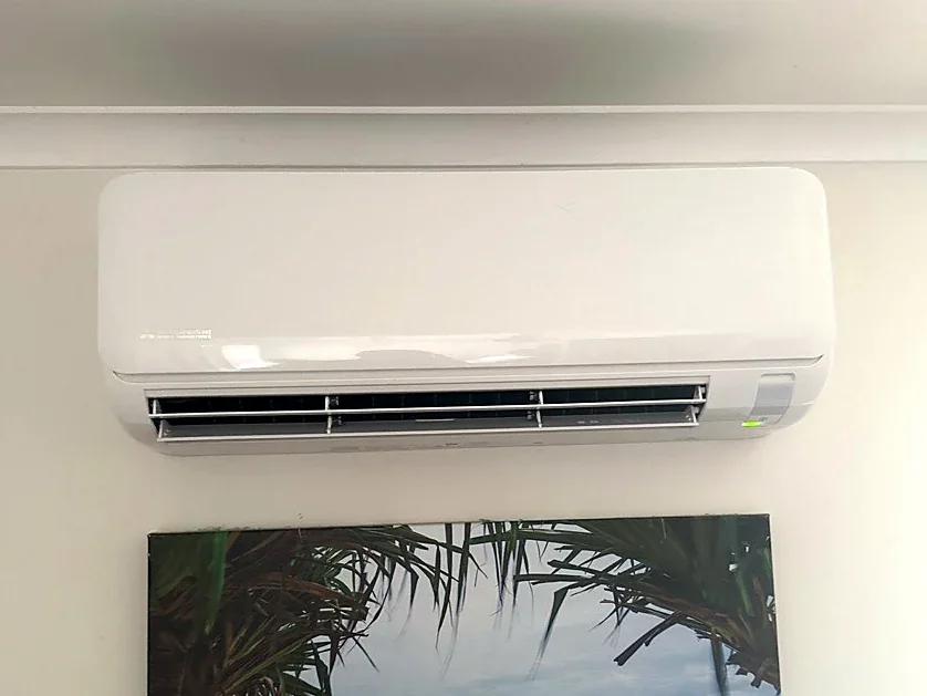 Split system installed above framed coastal artwork