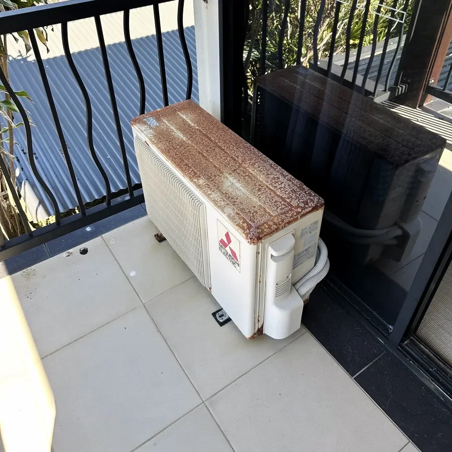 Old rusted outdoor air conditioning unit before replacement