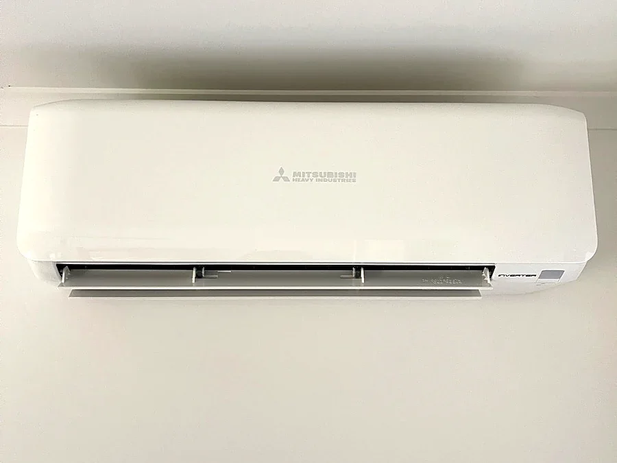 Mitsubishi Heavy Industries split system installed on a bright white bedroom wall