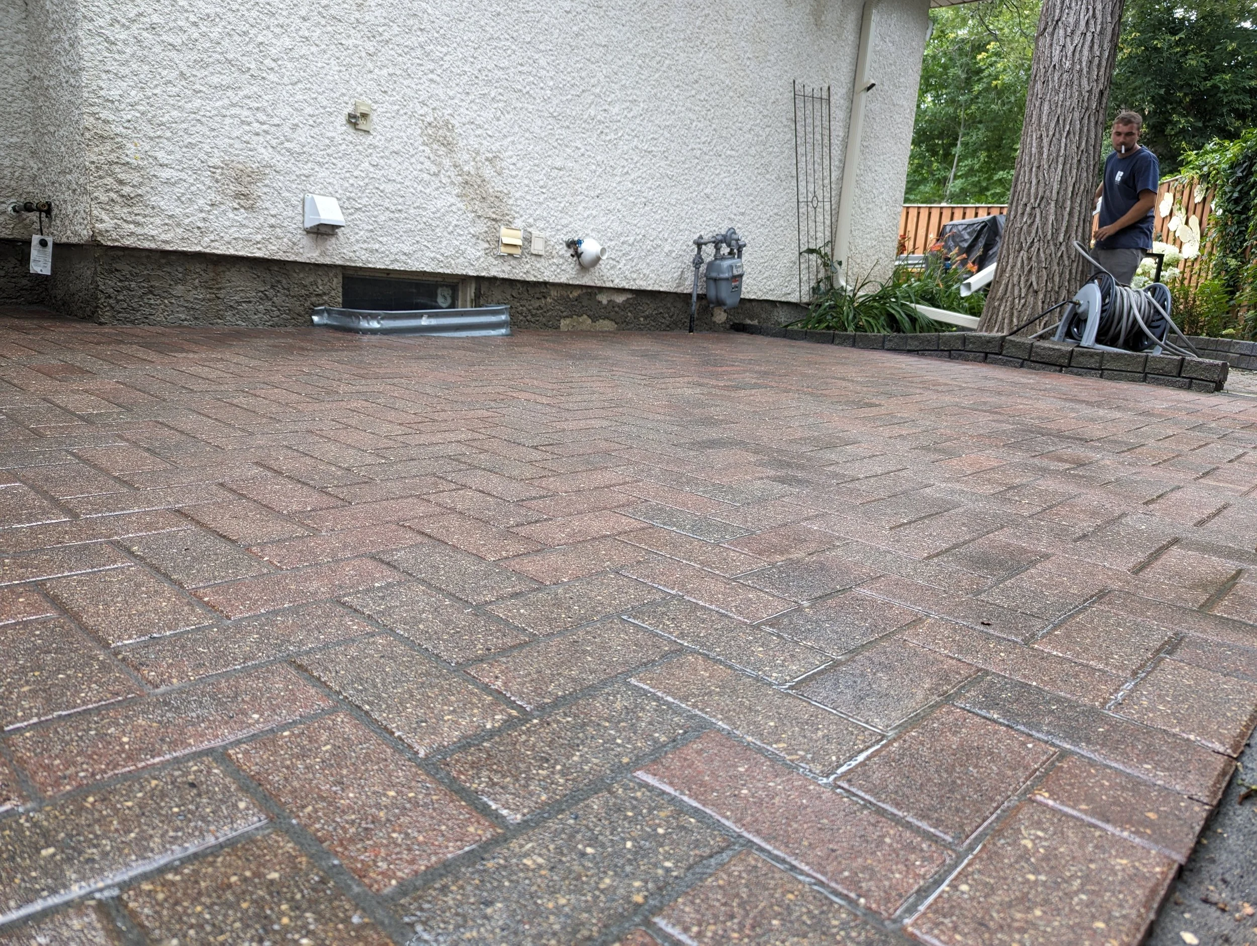 Re-leveled, cleaned, and polymeric sanded interlocking brick patio after repair in Winnipeg