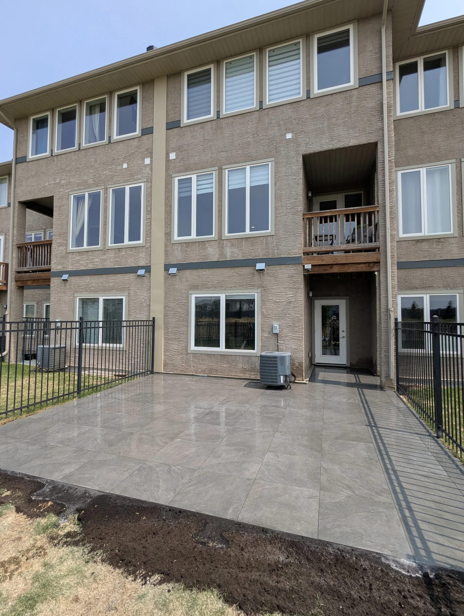 Luxury grey porcelain paver patio installation on Park West Drive Bridgwater Winnipeg