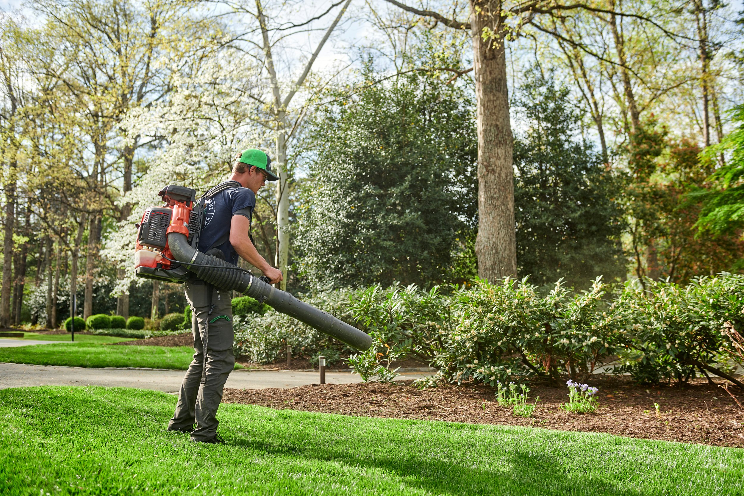 Our employee using a leaf blower in someone's yard