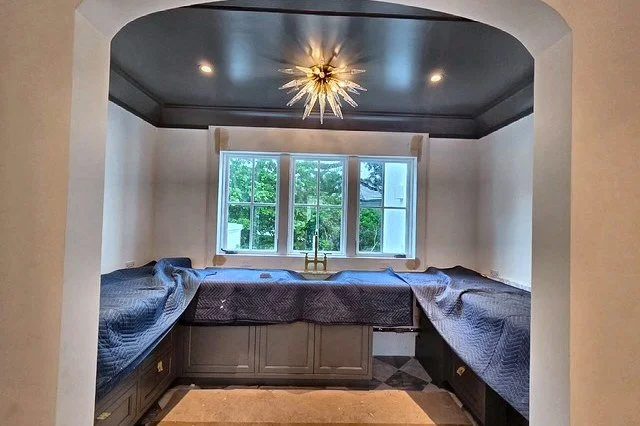 Custom home dining nook with a statement light fixture and recessed lights